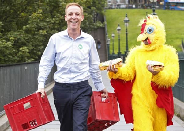 Jim Murphy is pictured with a newspaper reporter dressed as a chicken, as he resumes his 100 Streets in 100 Days tour. Picture: PA