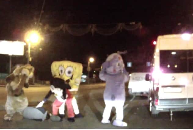 The four characters, with SpongeBob and Mickey in the centre, attack the man. Picture: YouTube/Screengrab
