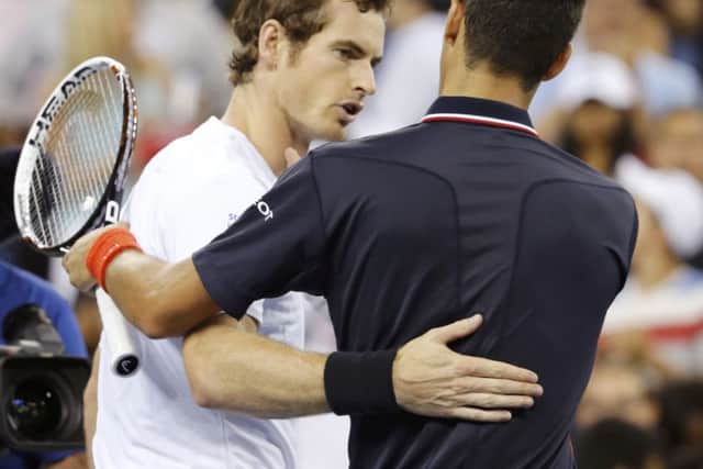 Andy Murray, left, shakes hands with Novak Djokovic after losing in four sets. Picture: Reuters