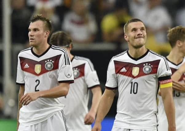 Germanys Kevin Grosskreutz, left, and Lukas Podolski trudge off after the 4-2 loss. Picture: AP