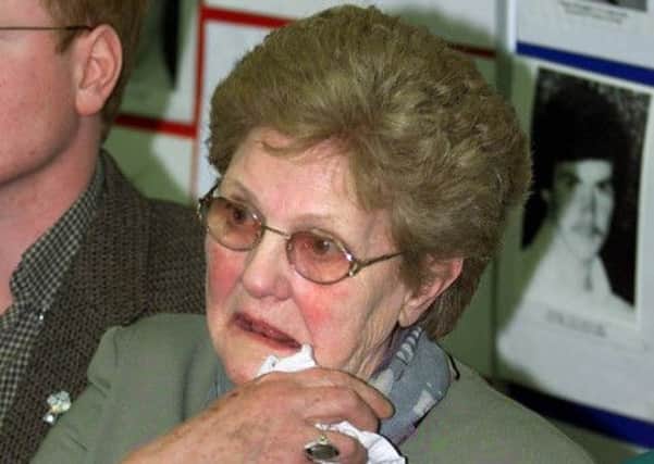 Carmel Lyuagh is overcome by grief as she holds a picture of her son  Jim who was killed by the SAS at an RUC station in Loughgall. Picture: AP
