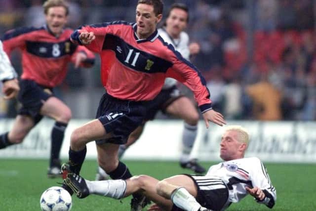 Alan Johnston, struggles with Germany's Thomas Strunz during the friendly at the Bremen Weser stadium, April 28,1999.Picture: Getty