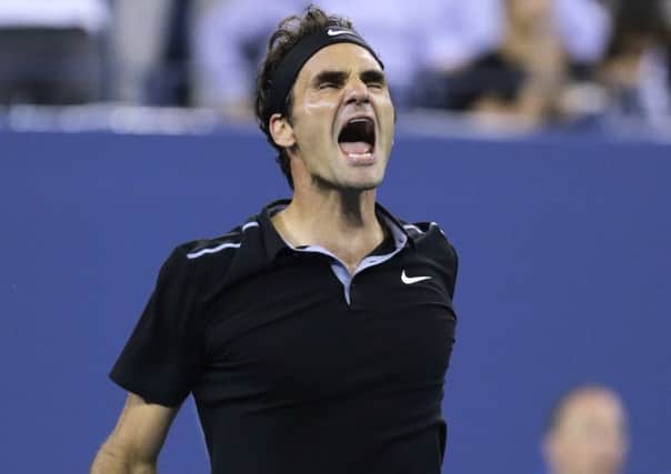 Roger Federer roars with delight after reaching the US Open semi-finals. Picture: AP