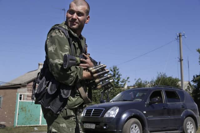 A Ukrainian rebel clutches his gun. Picture: AP