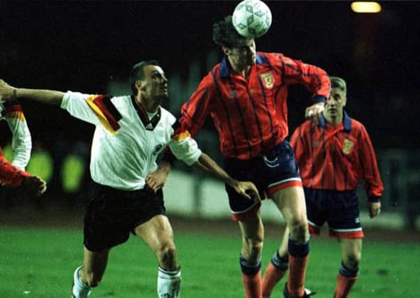 Duncan Ferguson (right) heads the ball away from Jurgen Kohler. Picture: SNS
