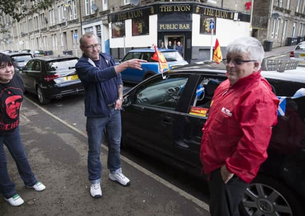 Douglas Thain by his car emblazoned with 'No Thanks' stickers and flags. Picture: Robert Perry