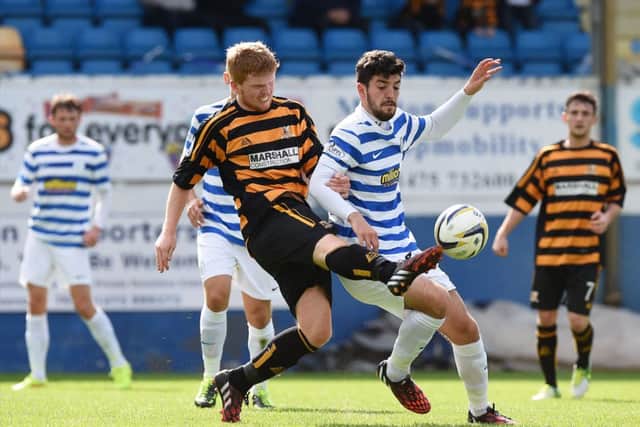 Alloa goalscorer Ryan McCord gets a leg in ahead of Mortons Thomas OWare at Cappielow. Picture: SNS