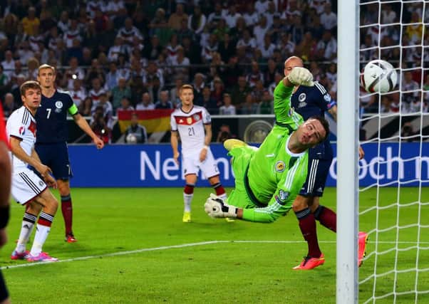 David Marshall can only watch as Thomas Muller's header loops in to the Scotland net. Picture: Getty
