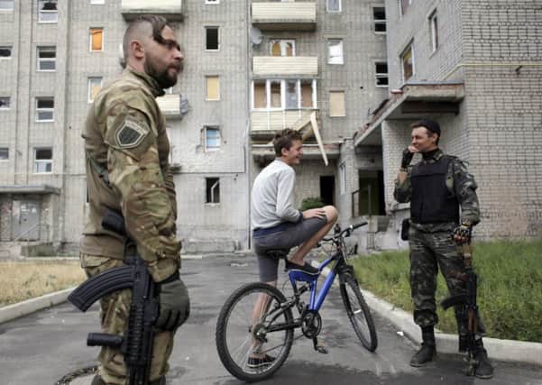 Ukrainian servicemen talk to residents in Avdeevka, near Donetsk. Picture: Getty