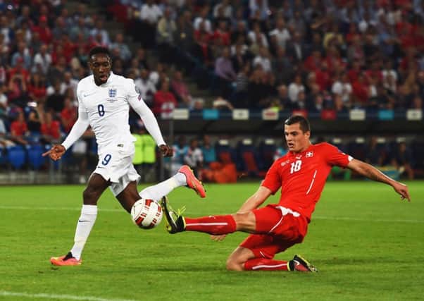 Two-goal striker Danny Welbeck is poised to slam home Englands opening goal against Switzerland last night. Picture: Getty