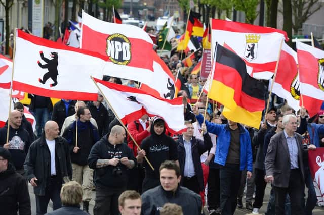 Supporters of the far-right NPD wave flags as they take part in a neo-Nazi demonstration in Berlin last year. Picture: Getty