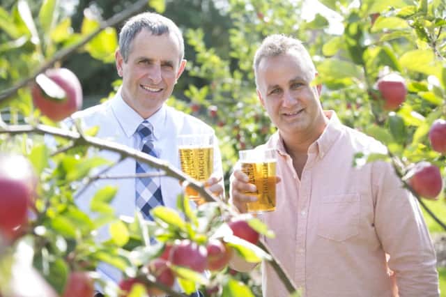 Martin Thatcher, left, and Dan Deluca celebrate the tie-up between their firms with a glass of the formers cider