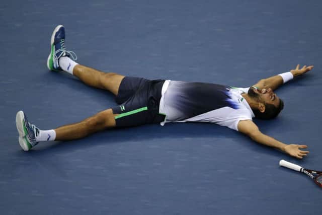 Marin Cilic lies flat out on Arthur Ashe court after beating Japans Kei Nishikori in the US Open. Picture: Getty