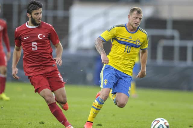 John Guidetti of Sweden holds off Turkey's Hakan Cinemre during the Under-21 clash. Picture: AP