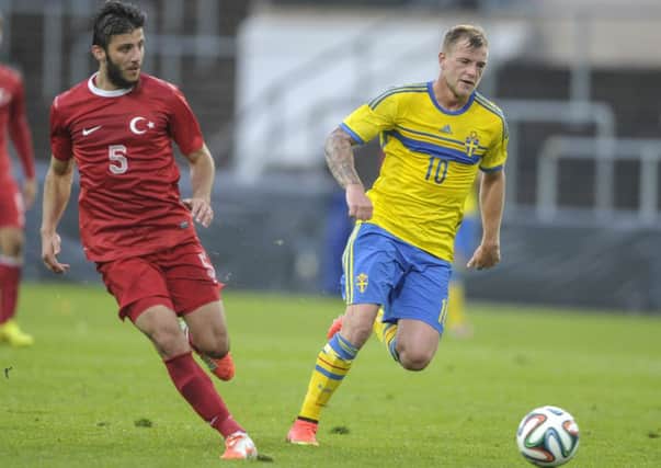 John Guidetti of Sweden holds off Turkey's Hakan Cinemre during the Under-21 clash. Picture: AP