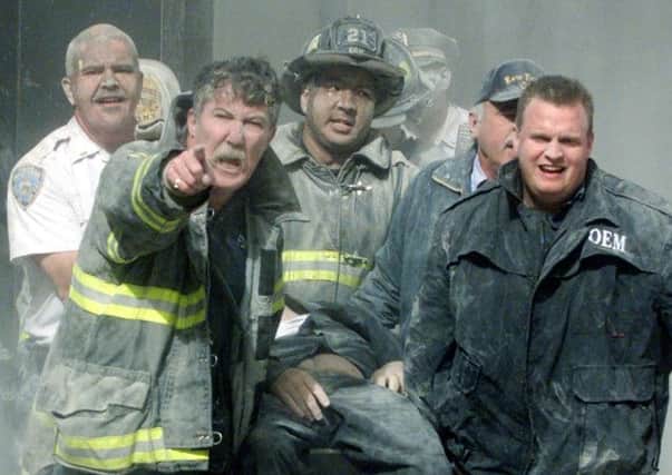 Rescue workers in action at the World Trade Center in New York following the terrorist attack on this day in 2001. Picture: Reuters