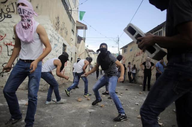 Palestinians hurl stones during clashes with Israeli police in east Jerusalem. Picture: Reuters