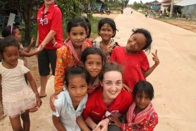 Heather Penman with some of the Cambodian children she helped