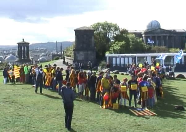 Catalan demonstrators form a v-shaped demonstration on Calton Hill. Picture: Ray Philp