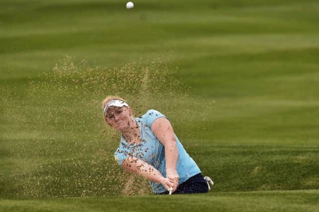 Kylie Walker plays out of a bunker on her way to a first-round 75. Picture: AFP/Getty