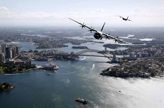 Two Royal Australian Air Forces aircraft fly over Sydney during a display. Picture: Reuters