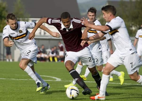 Hearts' Osman Snow tries to escape the clutches of Mark Gilhaney (right) and Scott Taggart (left). Picture: SNS