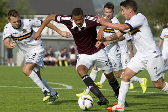 Hearts' Osman Snow tries to escape the clutches of Mark Gilhaney (right) and Scott Taggart (left). Picture: SNS