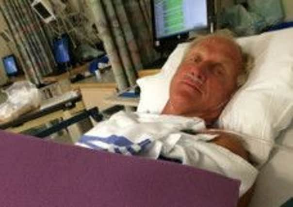 Greg Norman shows off his new fashion statement of purple foam, protecting his injured left hand