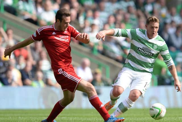 Kris Commons attempts to force his way clear of Aberdeens Andrew Considine. Picture: SNS