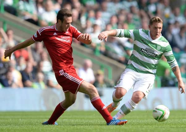 Kris Commons attempts to force his way clear of Aberdeens Andrew Considine. Picture: SNS