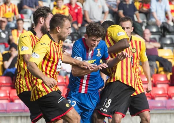 No way through for Ryan Christie as he found himself surrounded by Thistle players. Picture: SNS