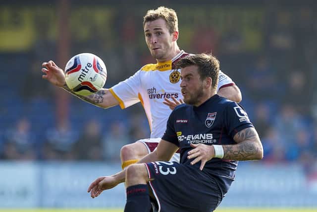 Graham Carey battles for possession with Josh Law, left, during Saturdays game in Dingwall. Picture: SNS