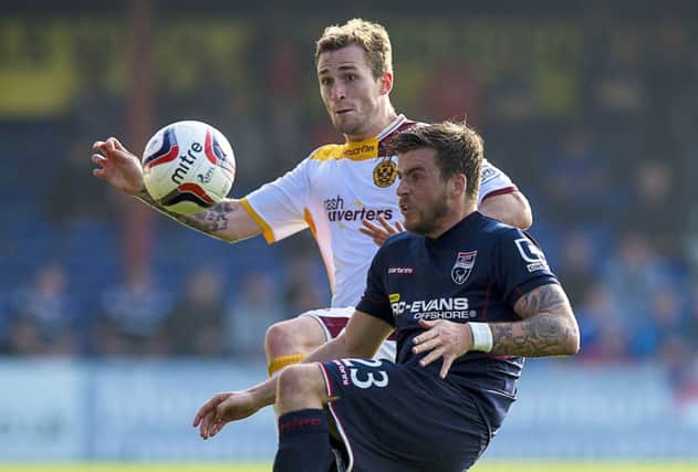 Graham Carey battles for possession with Josh Law, left, during Saturdays game in Dingwall. Picture: SNS