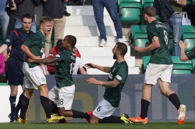 Substitute Jason Cummings, left, is mobbed by his team-mates after scoring Hibernians late winner. Picture: SNS