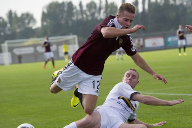 Dumbartons Andy Graham slides in to tackle Billy King.  Picture: SNS