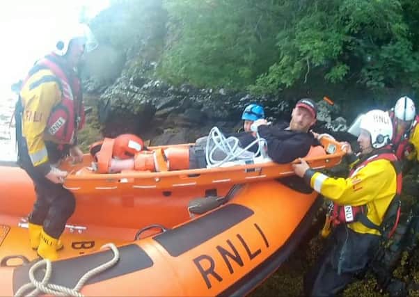 The rescued canoeist being transferred to the lifeboat. Picture: hemedia