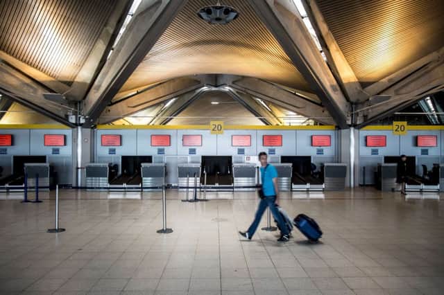 A passenger walks though a deserted Lyon Airport yesterday. Picture: Getty