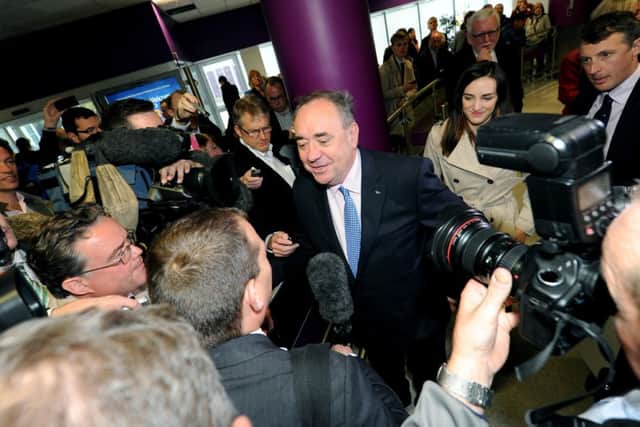 Alex Salmond is at the centre of a media scrum as he joined pro-independence business leaders at Edinburgh Airport. Picture: Lisa Ferguson