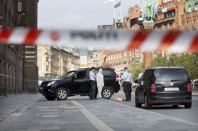 Police and a forensics officers at the scene of the incident in the centre of Copenhagen. Picture: AP