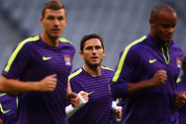 Manchester City skipper Vincent Kompany,right, says the club are asking the players to win the Champions League now. Picture: Getty