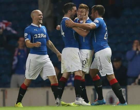 Nicky Clark, left, and Darren McGregor, right, congratulate matchwinner Lewis Macleod. Picture: Getty