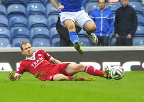 Mark Reynolds tackles Steve May. Picture: Robert Perry