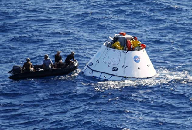 Recovery crew with a test version of Nasas Orion capsule this week. Picture: Reuters