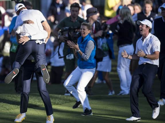 Martin Kaymer is embraced by Sergio Garcia after retaining the Ryder Cup at Medinah. Picture: AFP