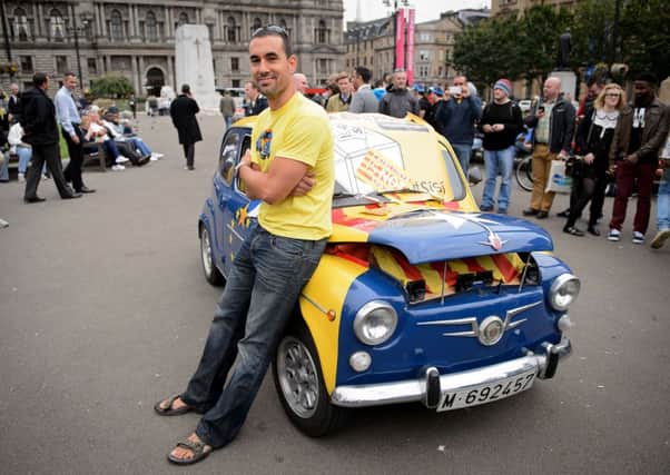 Oriol Pallares poses with the decorated car. Picture: AFP