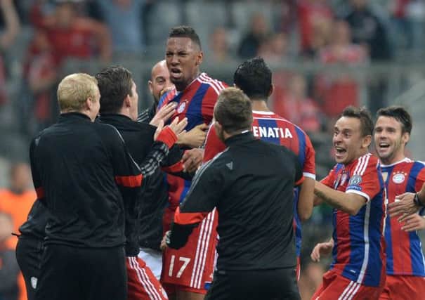 Jerome Boateng and his teammates celebrate his 89thminute winner. Picture: Christof Stache/AFP/Getty