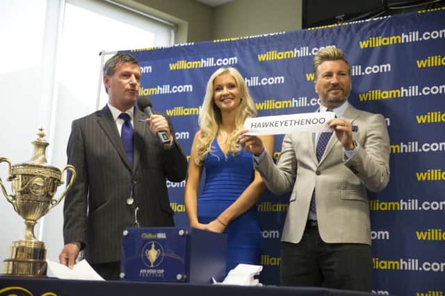 Miss Scotland Ellie McKeating and Robbie Savage, right, at the draw. Picture: PA