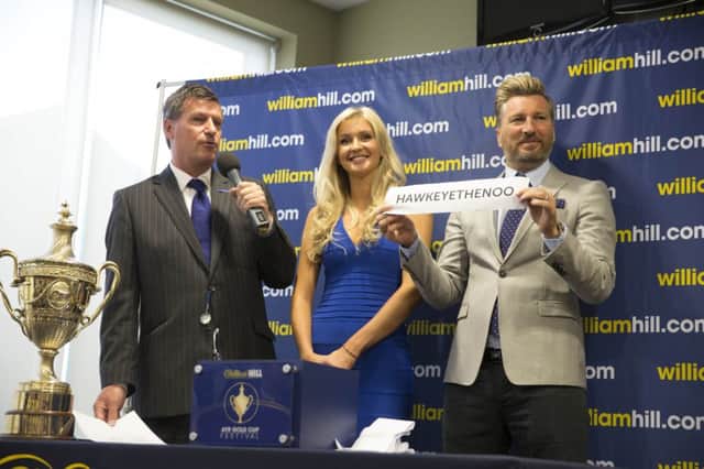Miss Scotland Ellie McKeating and Robbie Savage, right, at the draw. Picture: PA