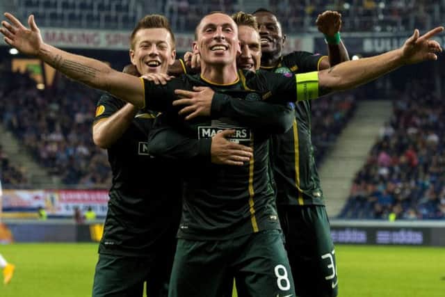 Celtic captain Scott Brown (centre) celebrates his wonder strike. Pic: SNS