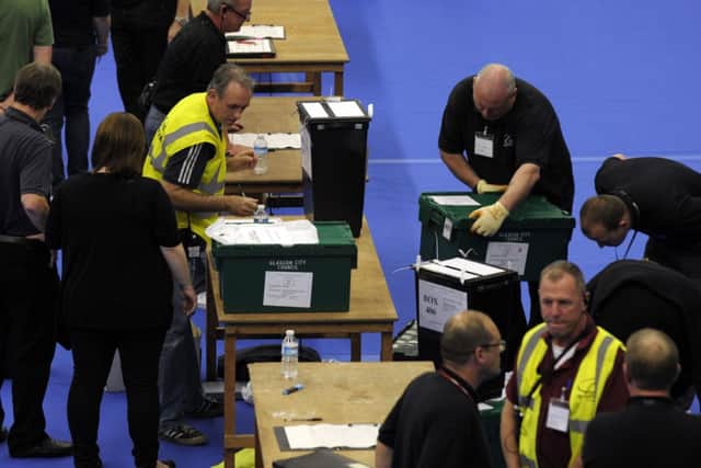 Ballot boxes are brought for vote counting at the Emirates Sports Arena, Glasgow. Pic: AFP